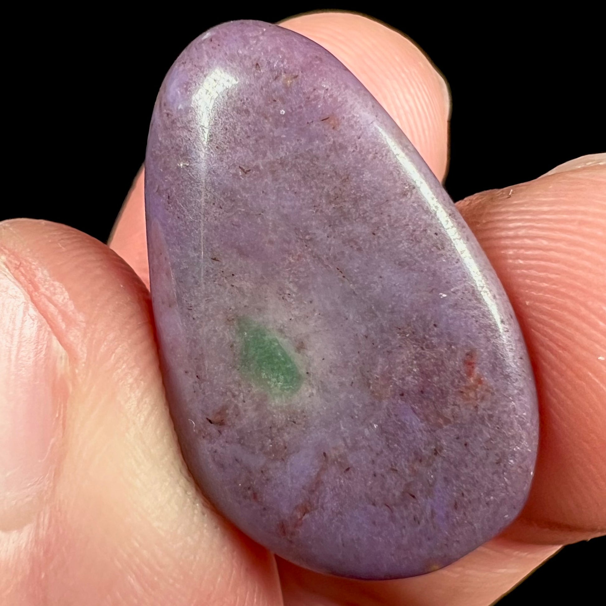 A tumbled purple turkiyenite jade stone from Borsa, Turkey.  The stone has a green jadeite inclusion.
