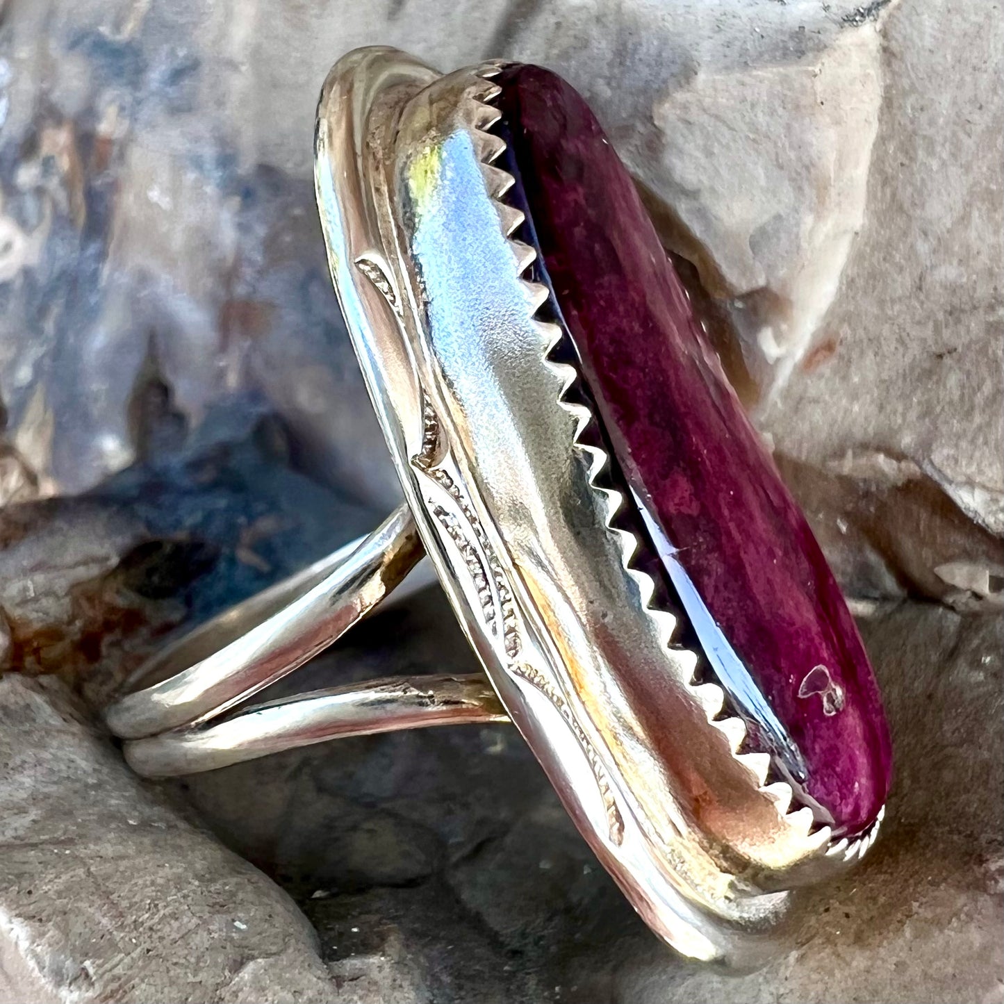 A sterling silver Navajo style ring set with a purple spiny oyster shell.