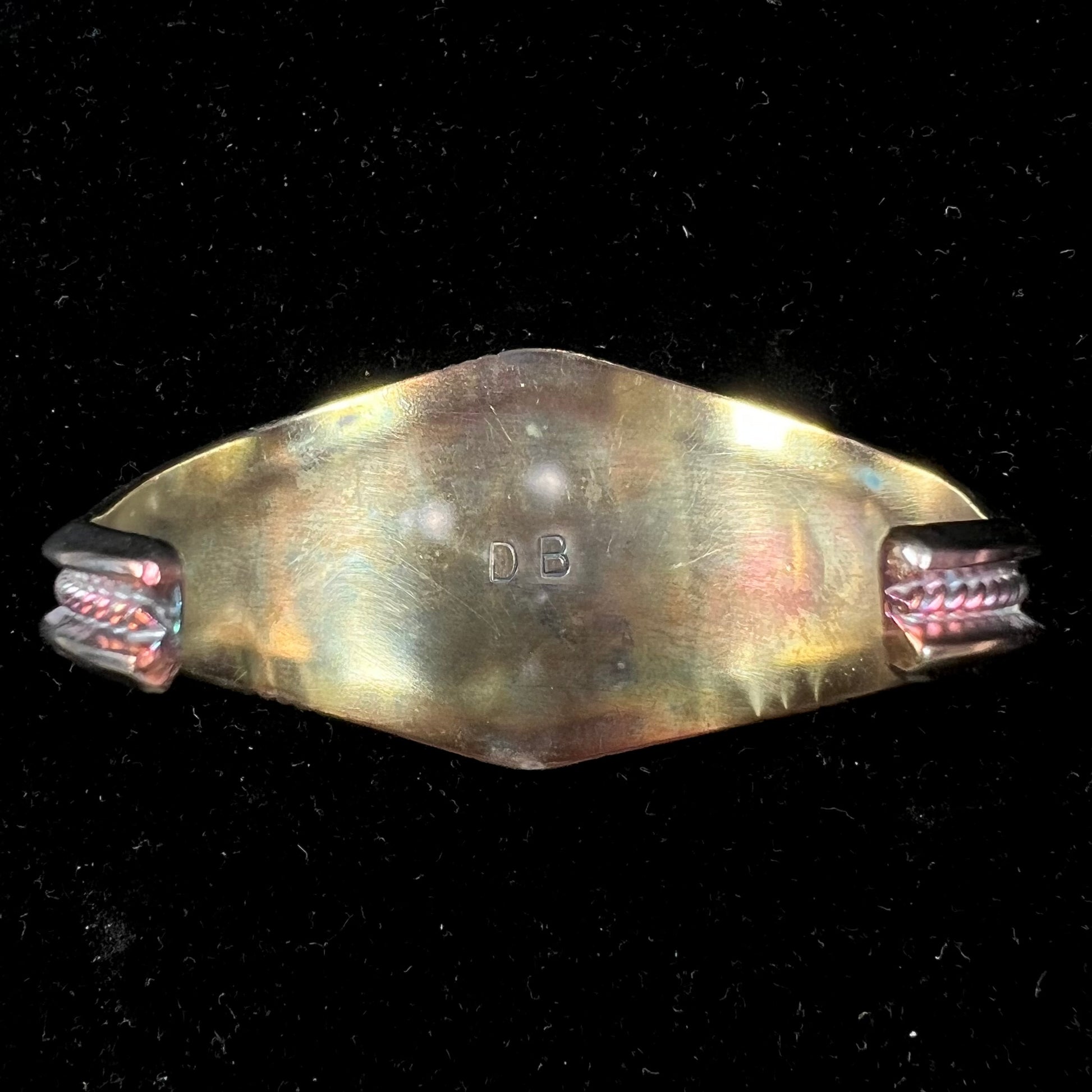 A men's Navajo three stone turquoise cuff bracelet handmade by artist, Dean Brown.  The silver has an iridescent purple patina.