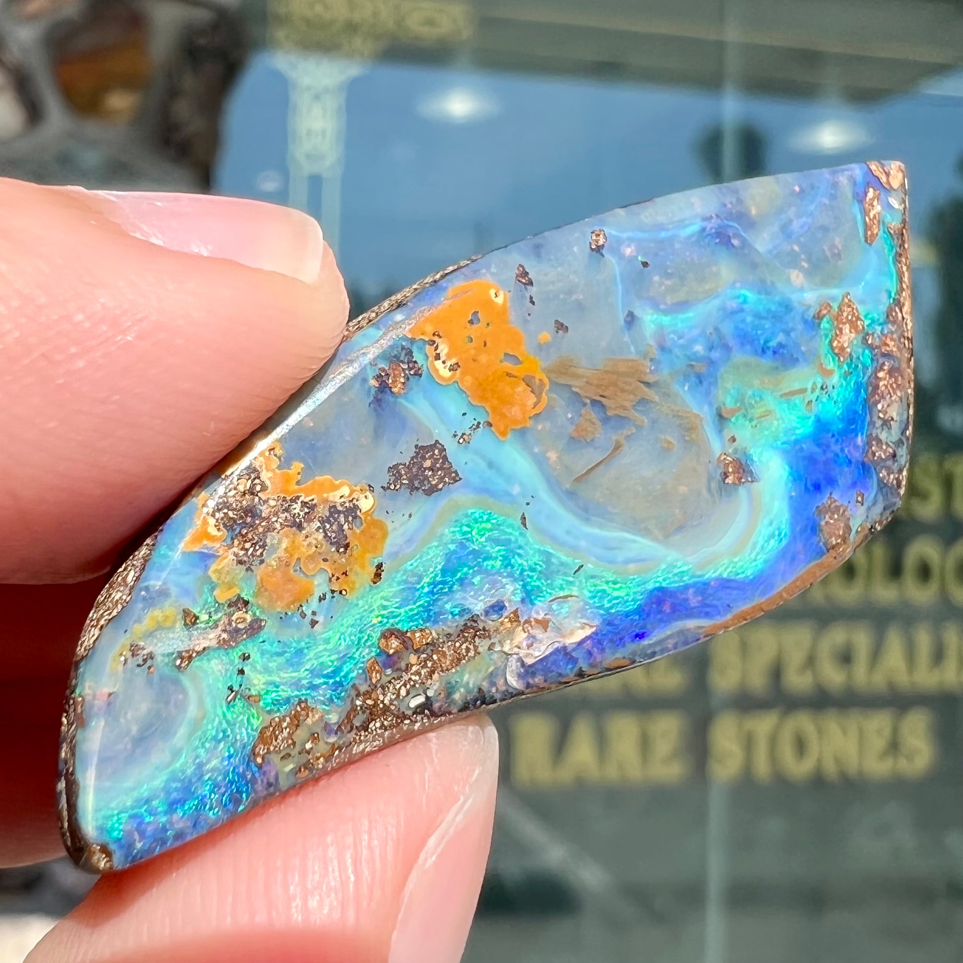 A freeform cut, loose black boulder opal stone from Queensland, Australia.