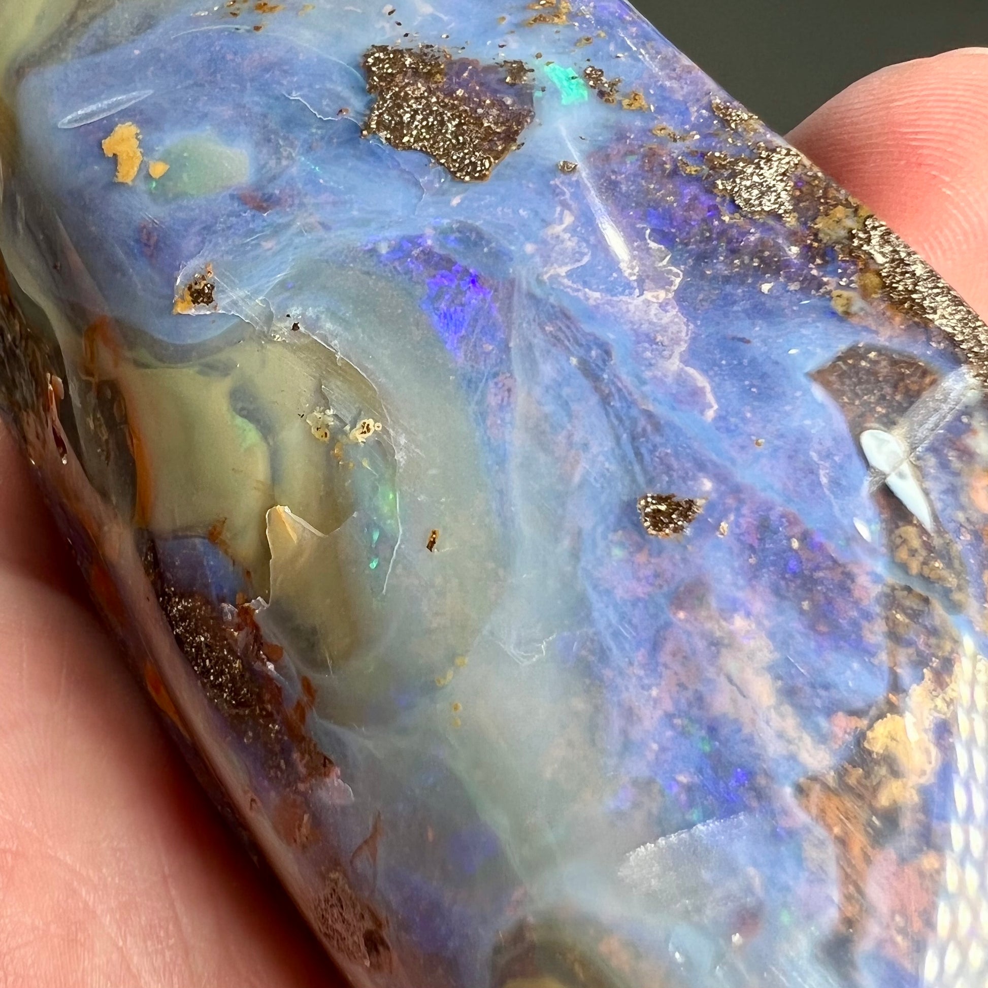 A 7 inch long polished blue Quilpie boulder opal specimen from Queensland, Australia.