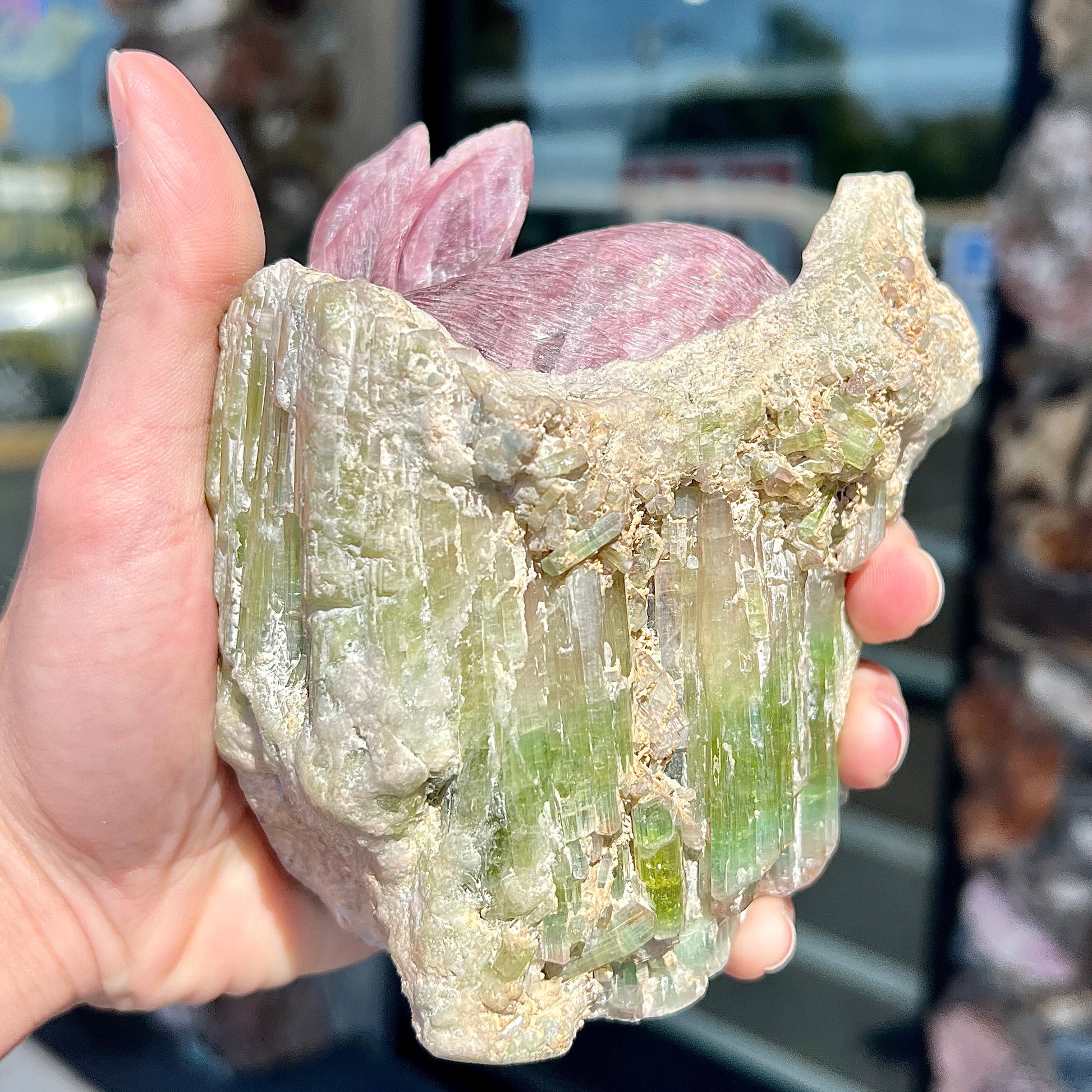 A stone rabbit carved from a conglomeration of watermelon tourmaline crystals by artist, Ronald Stevens.