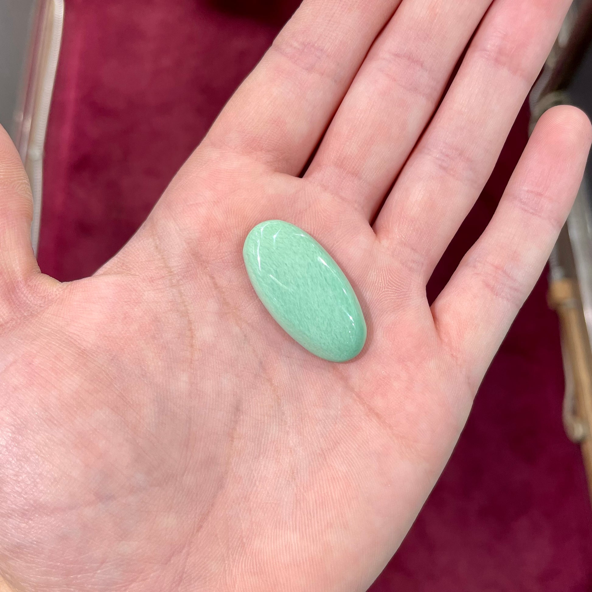A loose, oval cabochon cut variscite stone from Utah, USA.