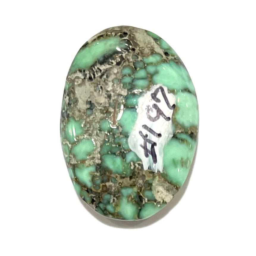 A loose, oval cabochon cut variscite stone from Utah, USA.