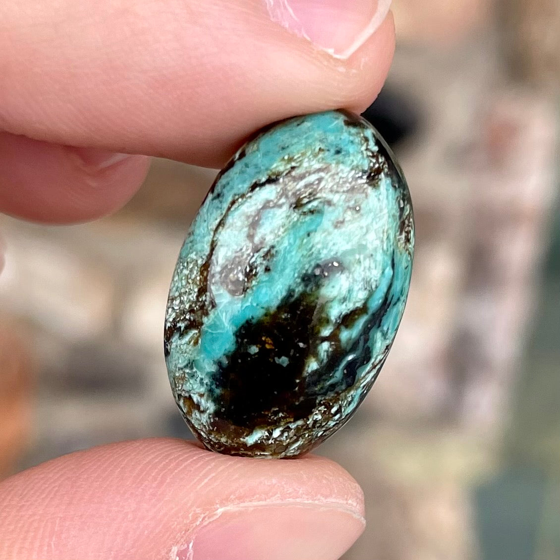 A loose, oval cabochon cut Royston turquoise stone from Nevada.