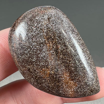 A loose, drop shaped Australian boulder opal from Quilpie Mining District.