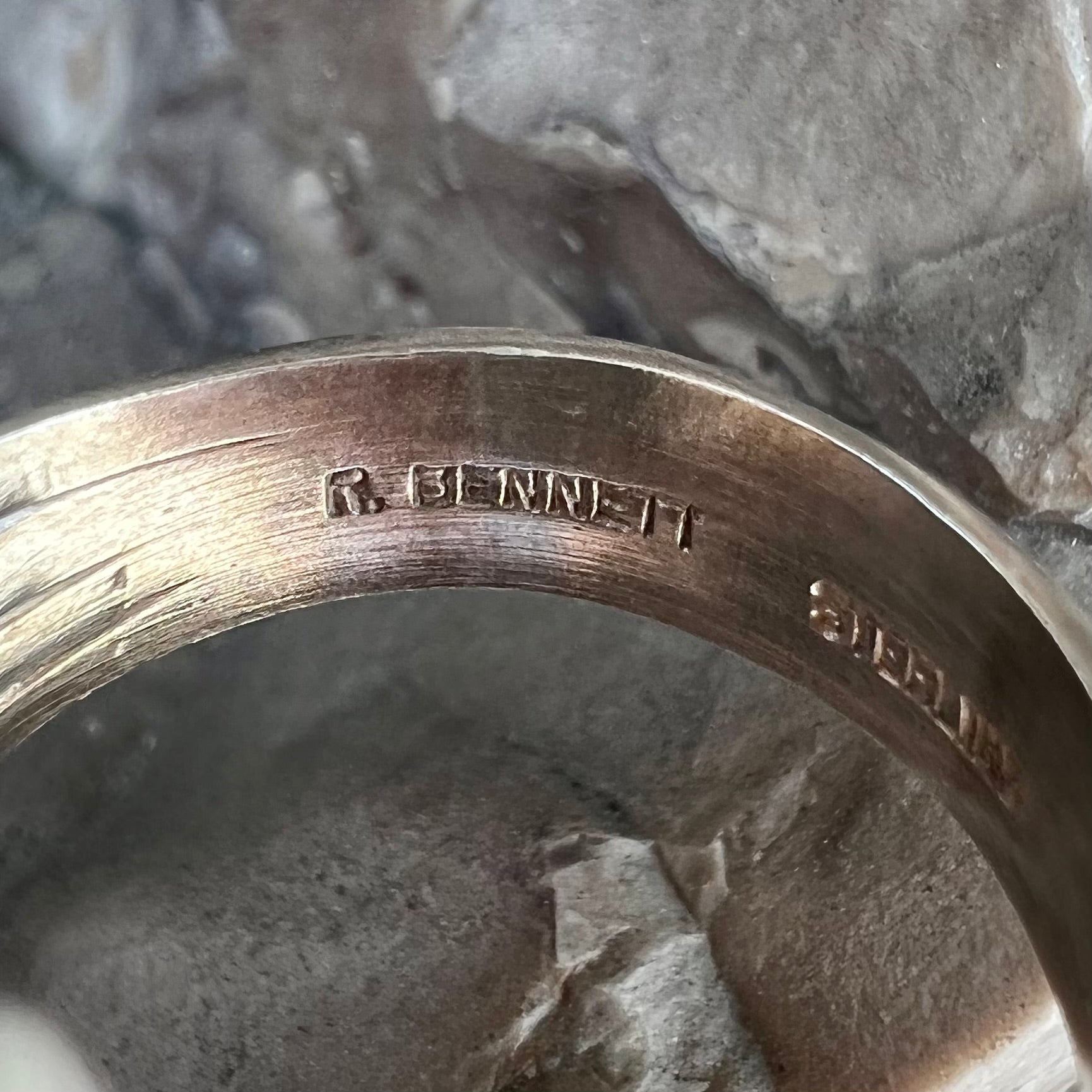 A Navajo style sterling silver lapis lazuli ring engraved with the words "R. Bennett".