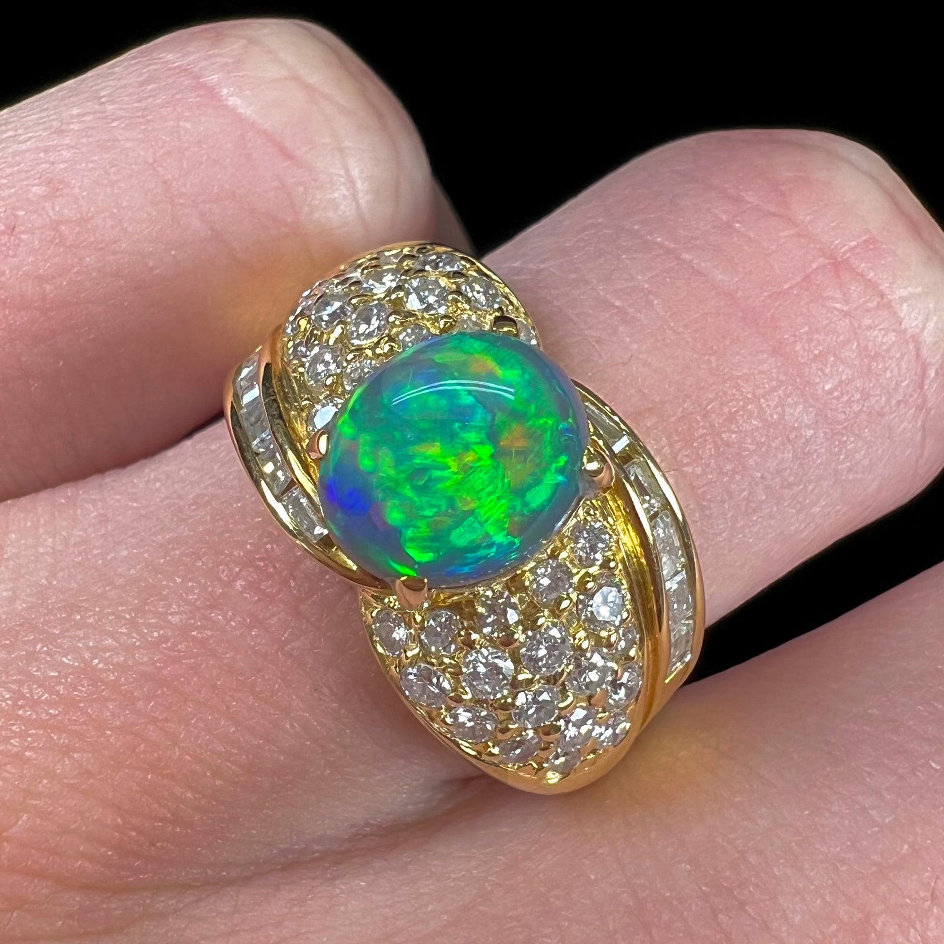 A natural, Australian black opal and diamond ring cast in 18 karat yellow gold..