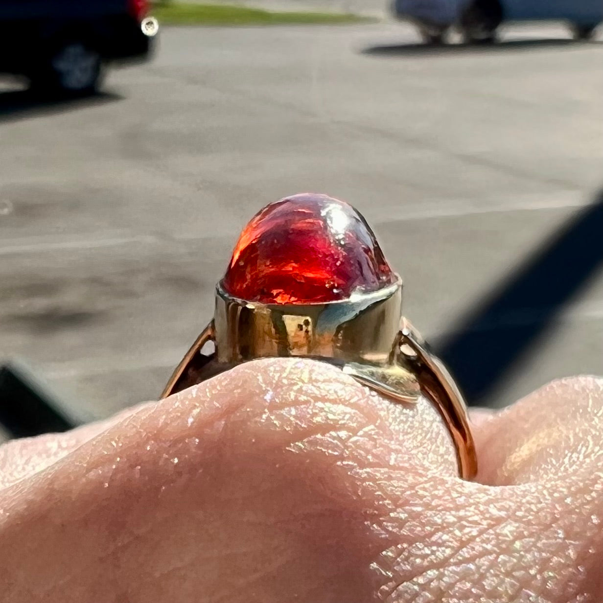 An oval cabochon cut Baltic amber stone set in a yellow gold ring and stamped "AMBER GUILD."