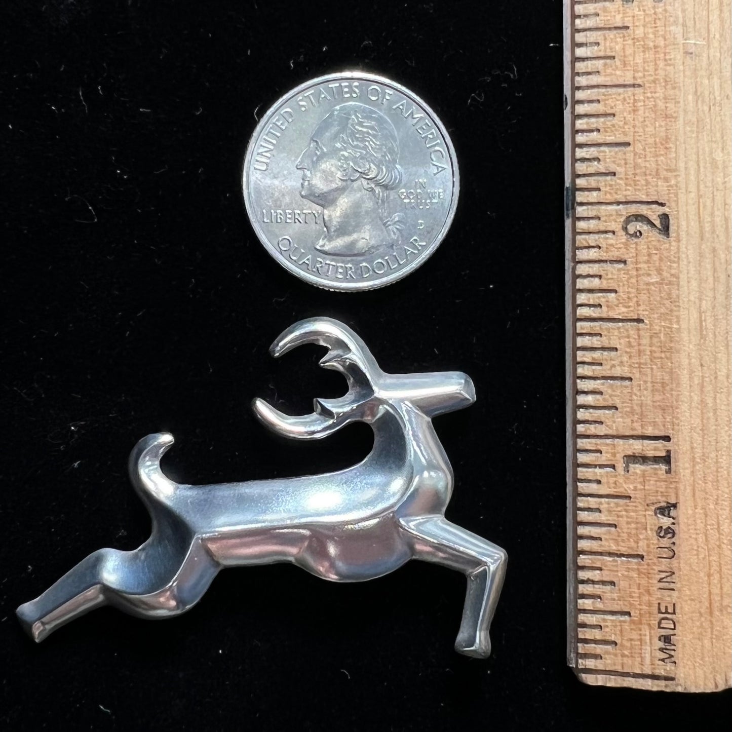 A silver brooch of a jumping deer handmade by Navajo artist Frances Jones.