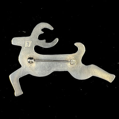 A silver brooch of a jumping deer handmade by Navajo artist Frances Jones.