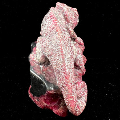 A stone chameleon lizard carved from natural rhodonite by artist, Ronald Stevens.