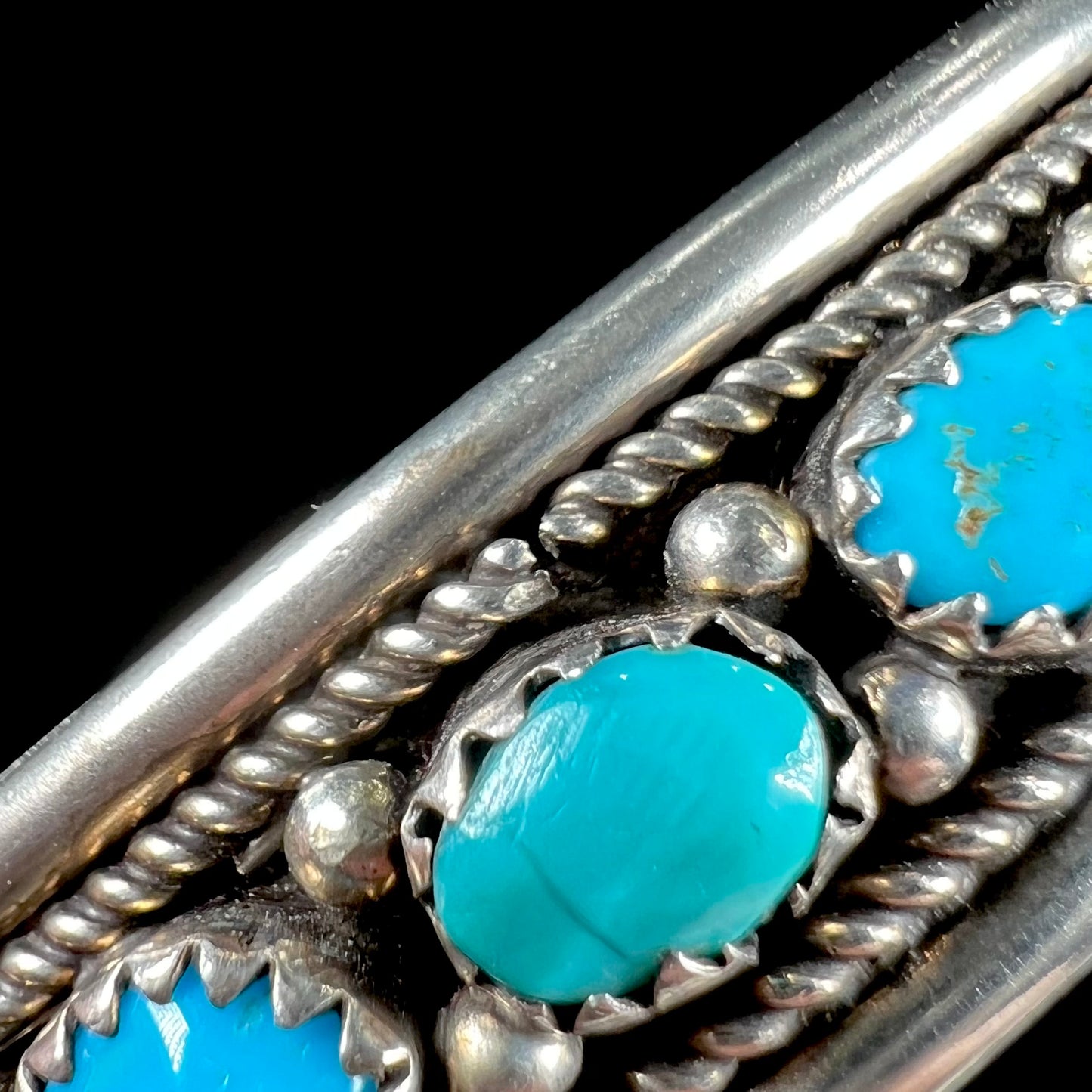 A silver ladies' turquoise and coral cuff bracelet, handmade by Navajo artist, John Delvin.