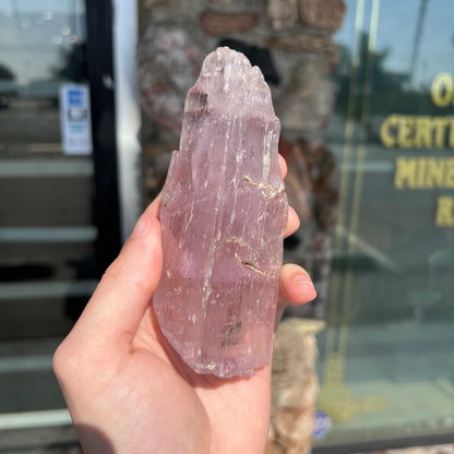 A five inch long pink kunzite crystal.  The crystal is purple when viewed down the ends.