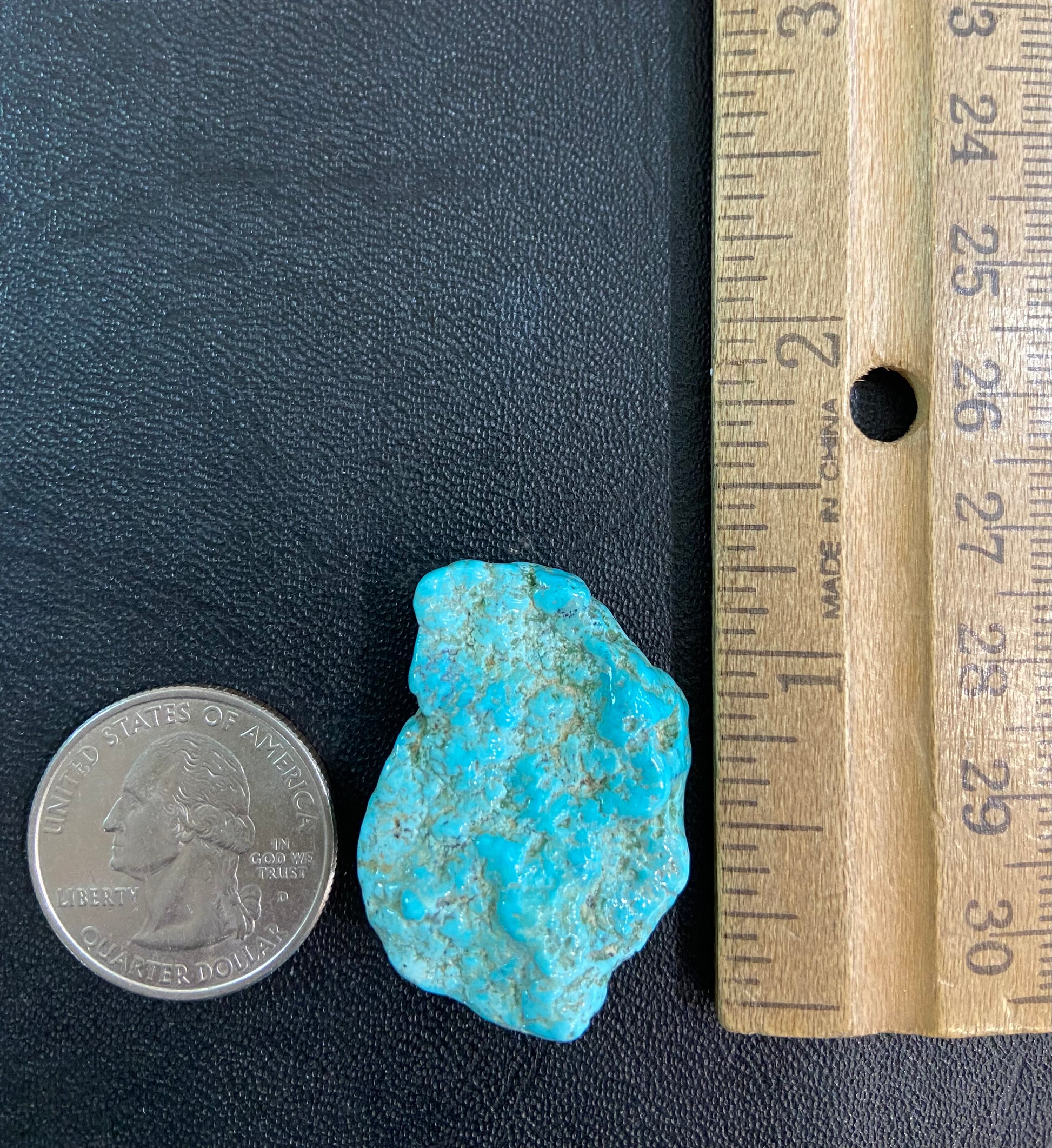 A loose, lightly polished nugget of Sleeping Beauty turquoise.