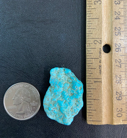 A loose, lightly polished nugget of Sleeping Beauty turquoise.