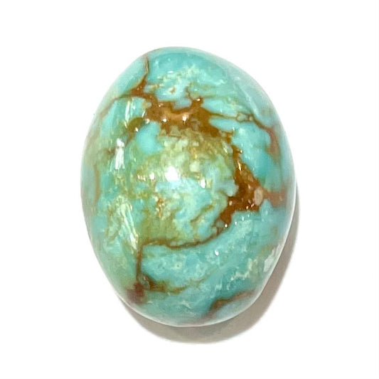 A loose, greenish blue turquoise stone with brown matrix from the Royston Mining District in Nevada.