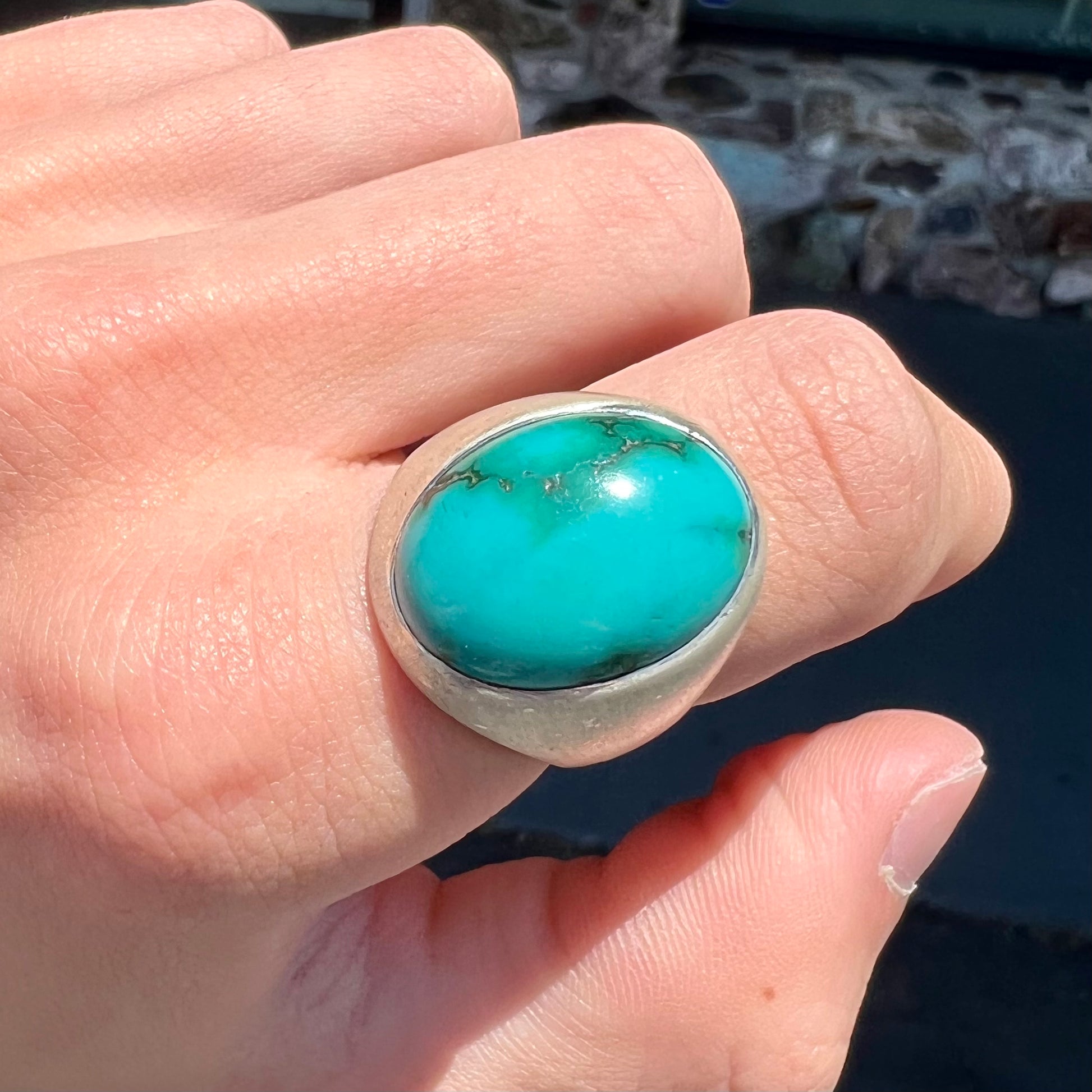 A men's textured silver turquoise solitaire ring.  The turquoise is from Royston Mining District, Nevada.