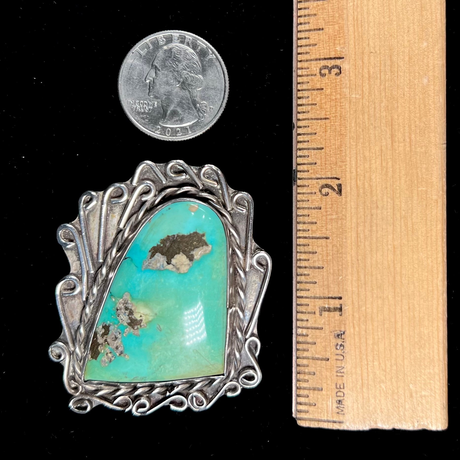 A sterling silver pendant made from greenish blue Royston turquoise, handmade by an unknown Hopi artist.