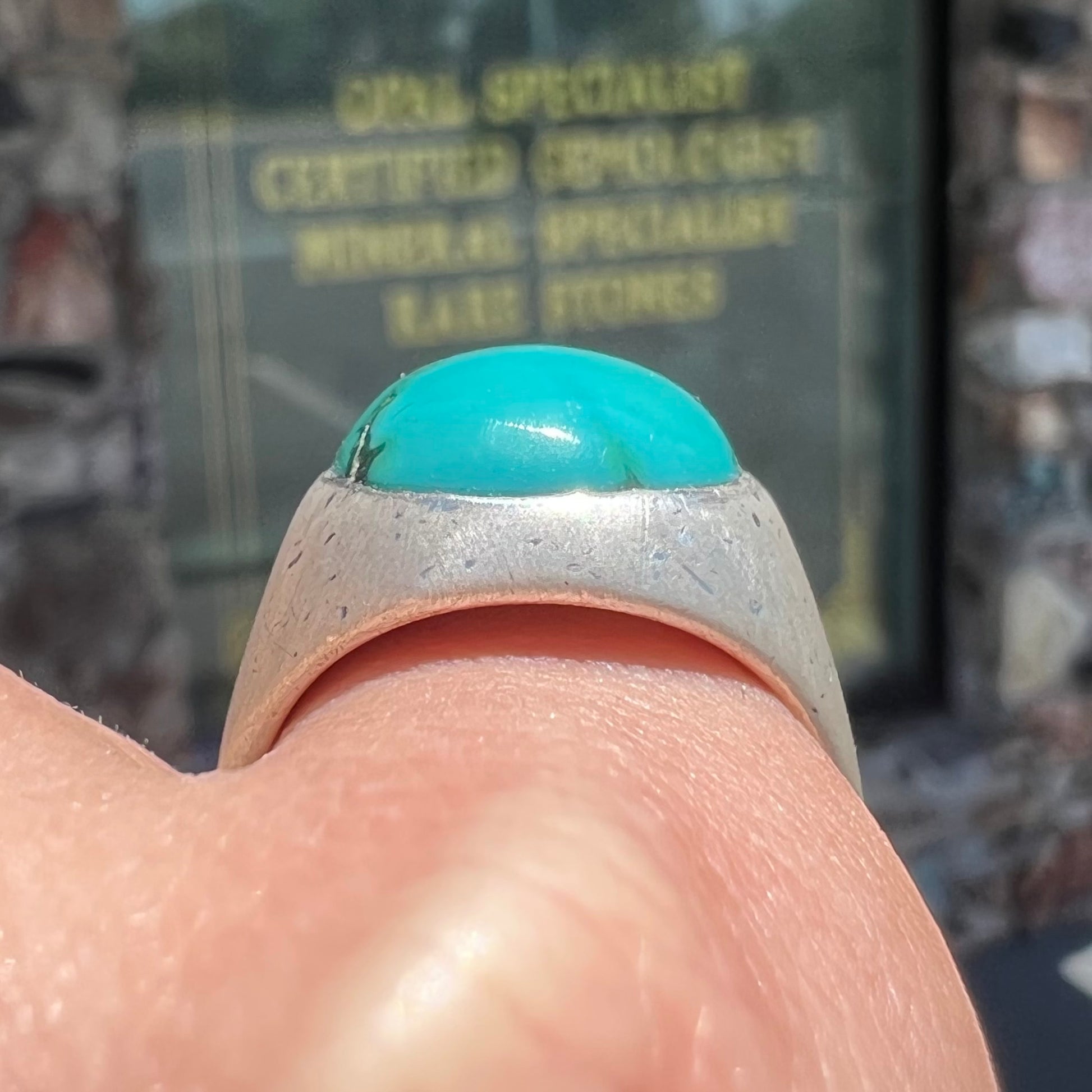 A men's textured silver turquoise solitaire ring.  The turquoise is from Royston Mining District, Nevada.