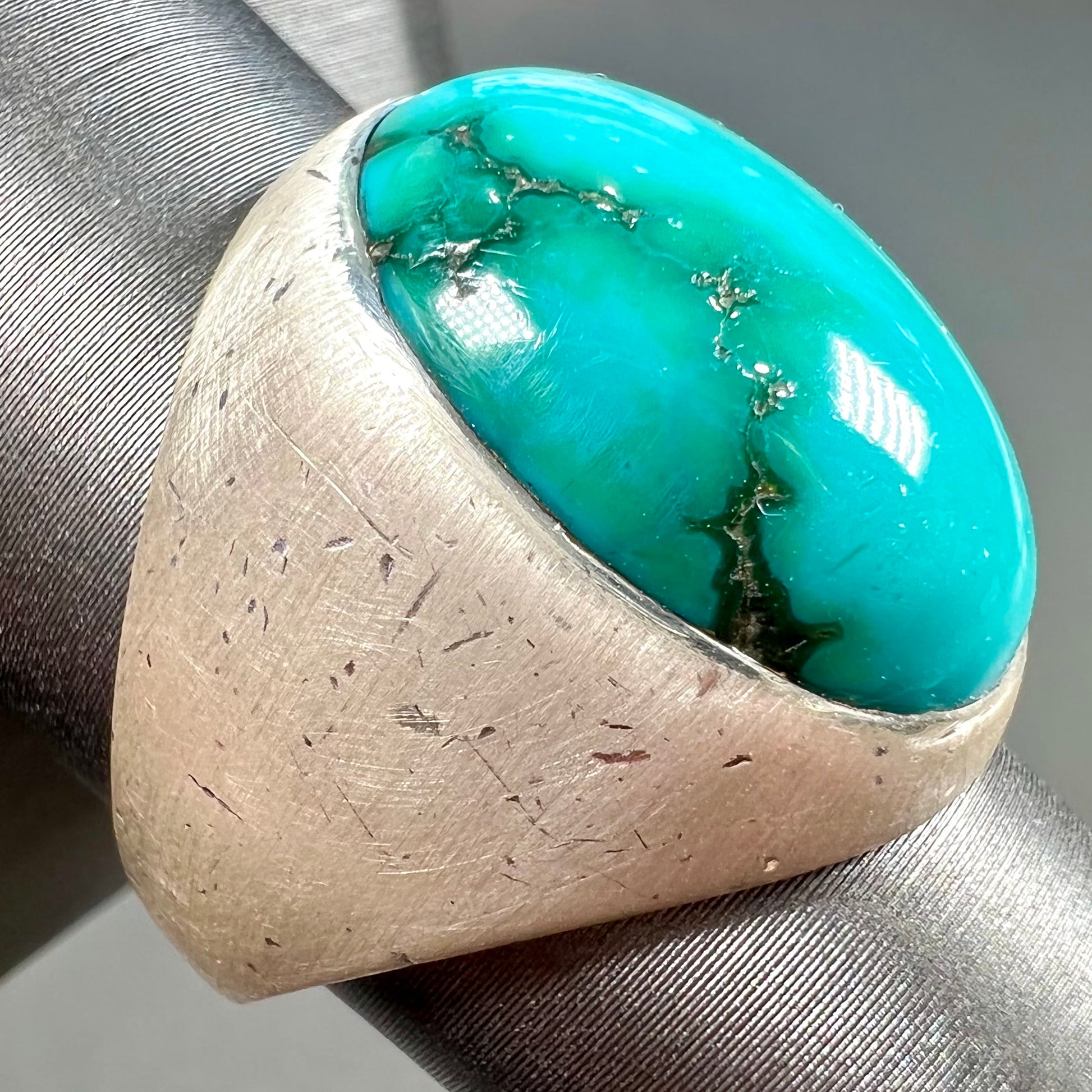 A men's textured silver turquoise solitaire ring.  The turquoise is from Royston Mining District, Nevada.