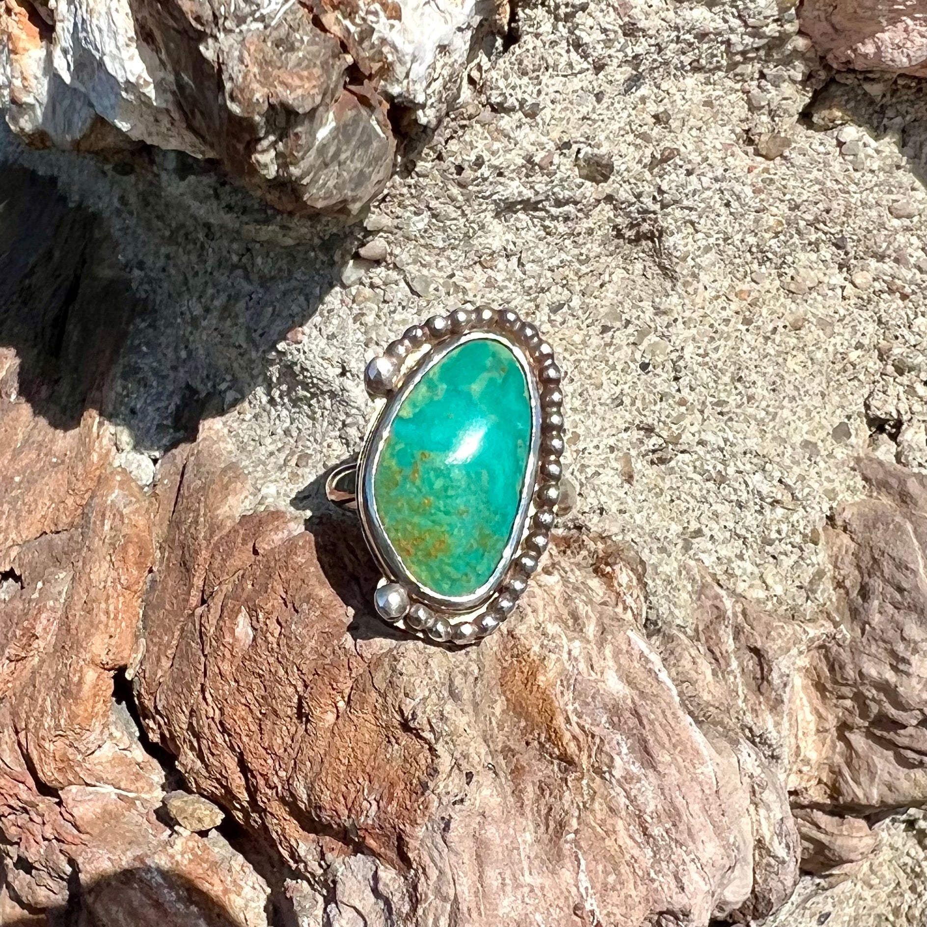 A sterling silver, Native American style green turquoise ring.  The turquoise is from the Royston Mining District.
