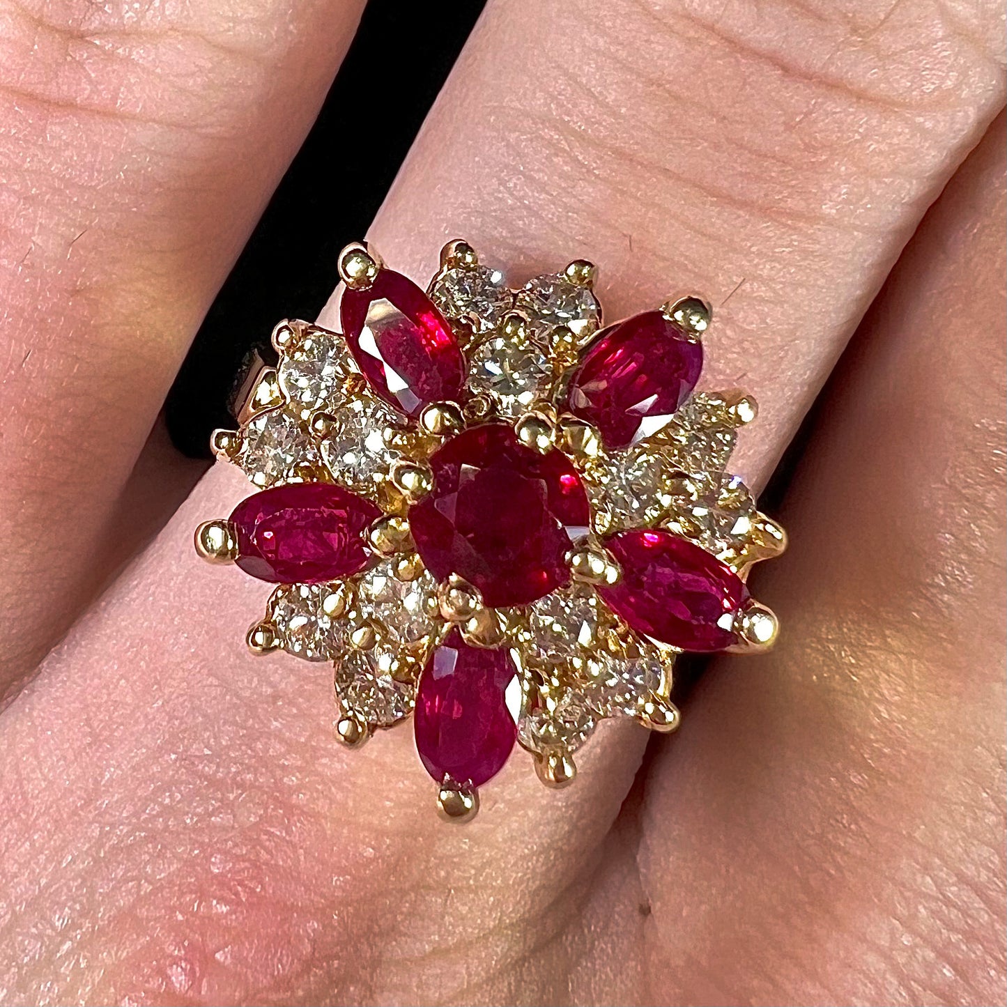 A ladies' vintage yellow gold cluster ring set with diamonds and pigeon blood red Burma rubies.