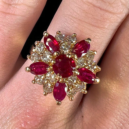 A ladies' vintage yellow gold cluster ring set with diamonds and pigeon blood red Burma rubies.