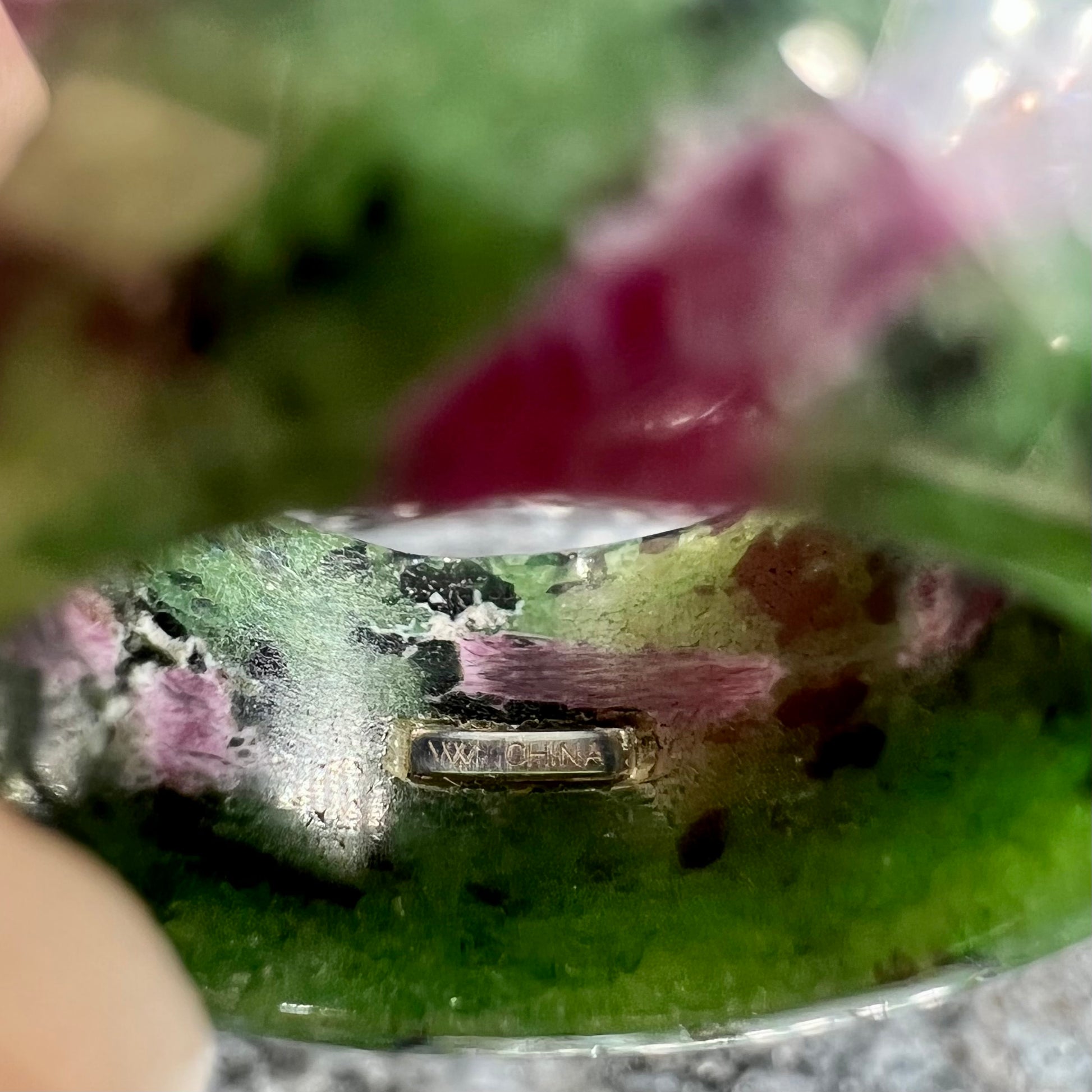 A faceted, carved stone ring made form ruby in zoisite.