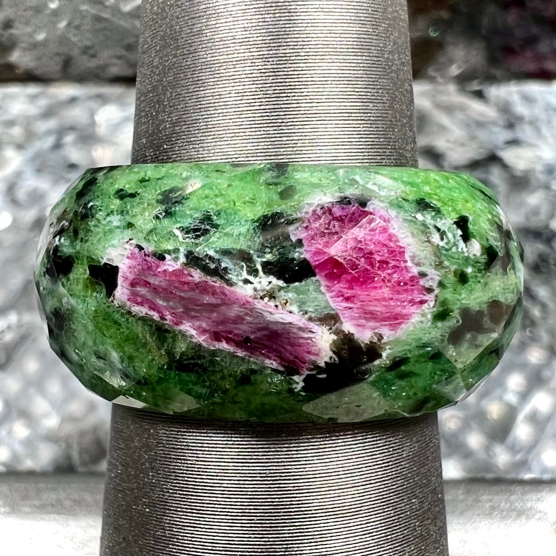 A faceted, carved stone ring made form ruby in zoisite.