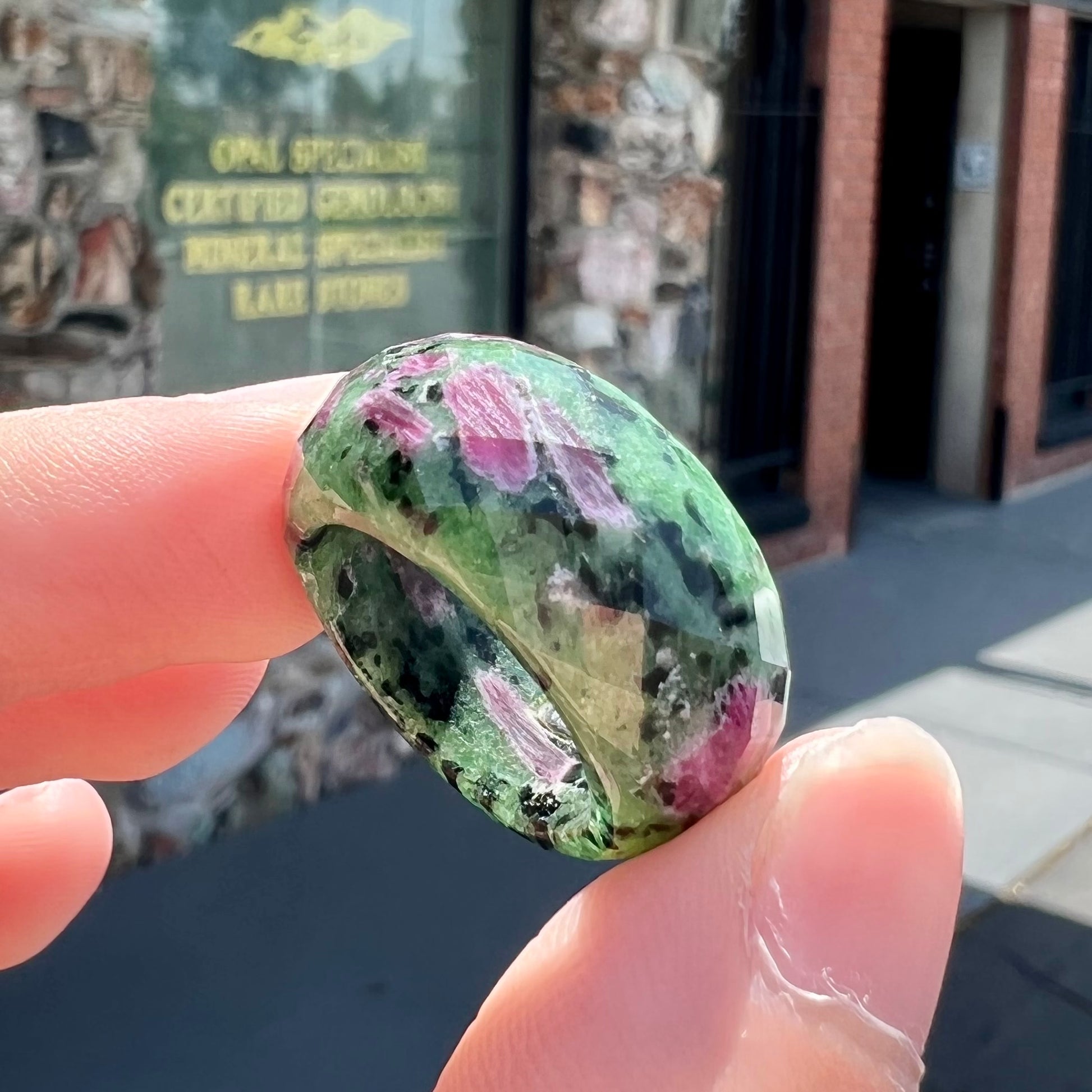 A faceted, carved stone ring made form ruby in zoisite.
