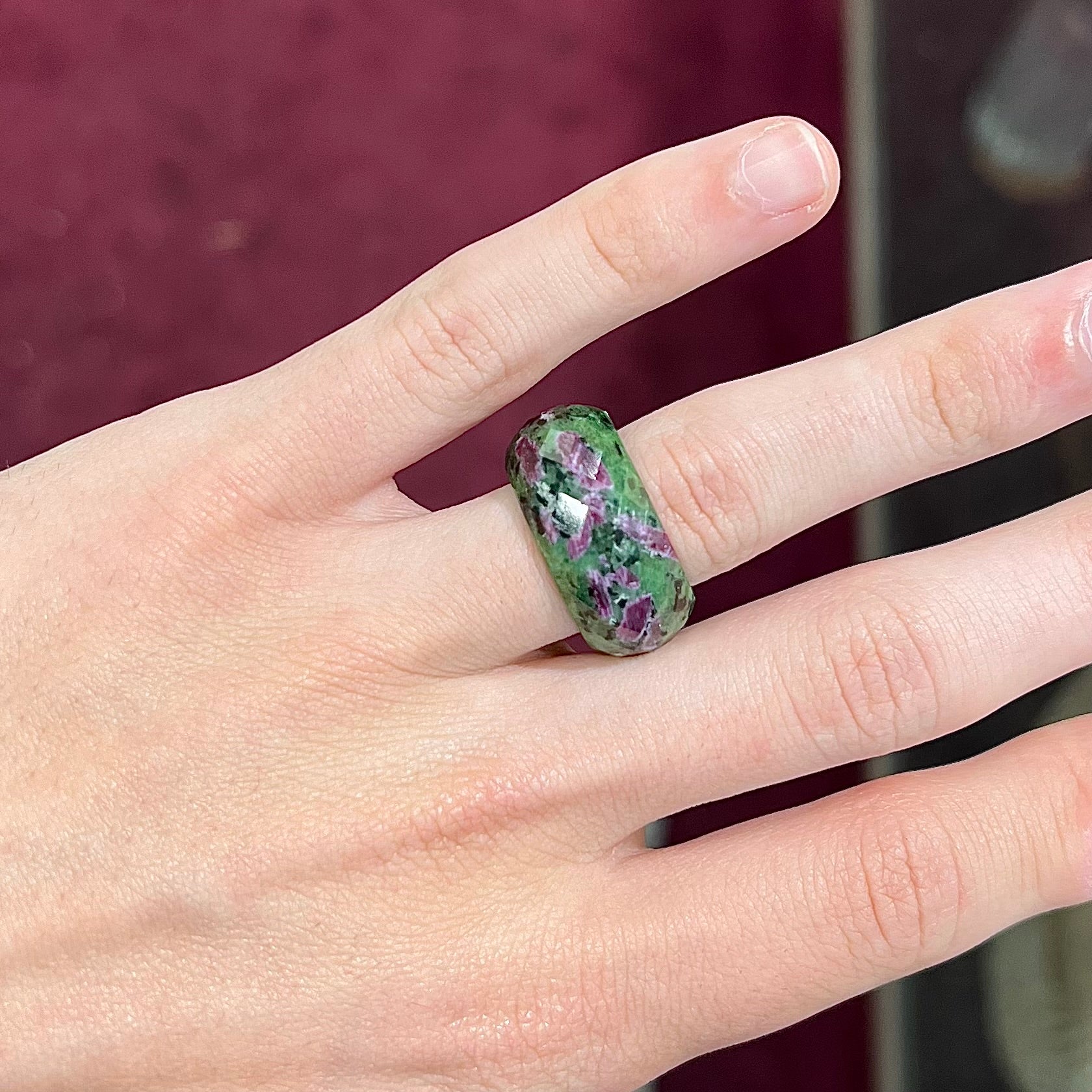 A faceted, carved stone ring made form ruby in zoisite.