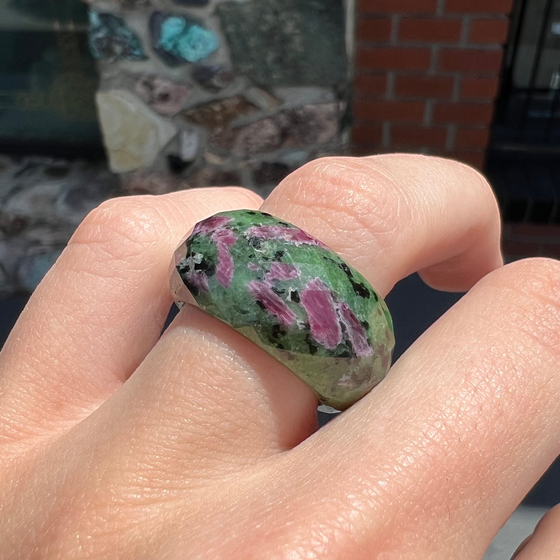 A faceted, carved stone ring made form ruby in zoisite.