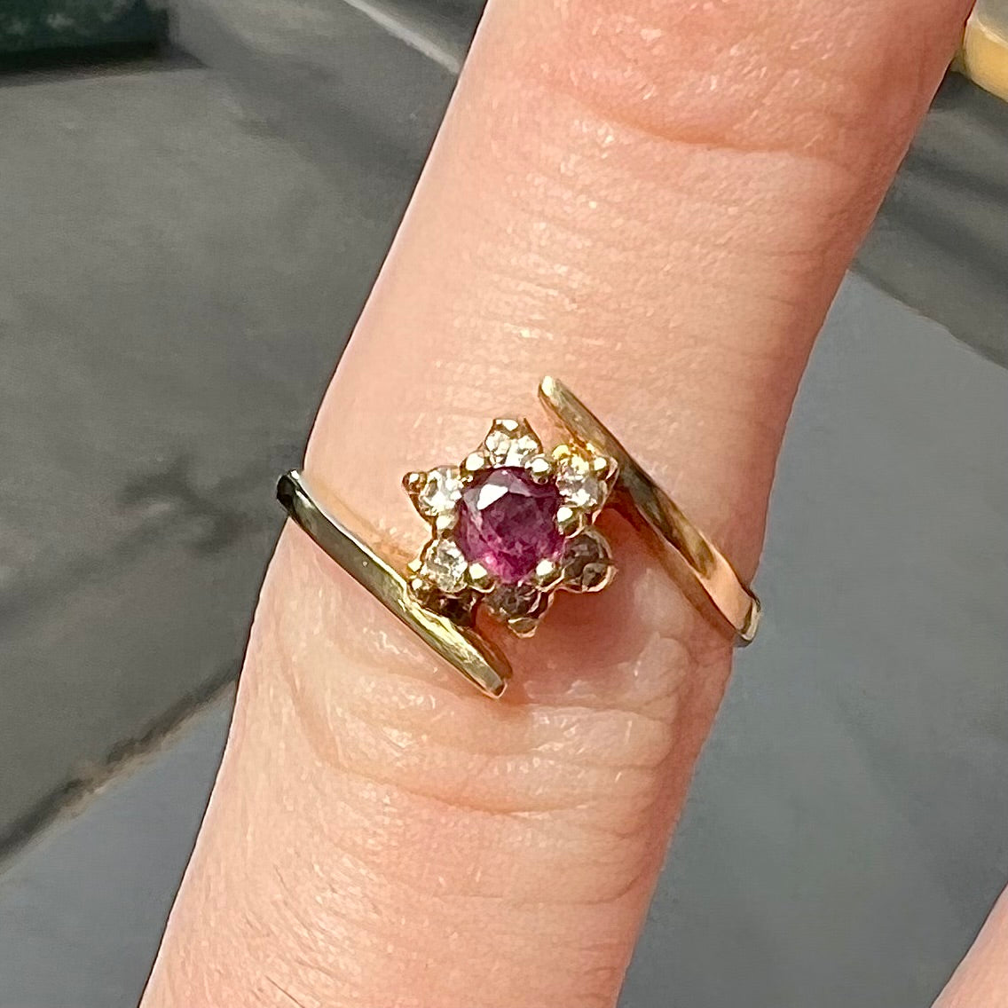 Custom twisted shank ruby and diamond halo yellow gold ring.