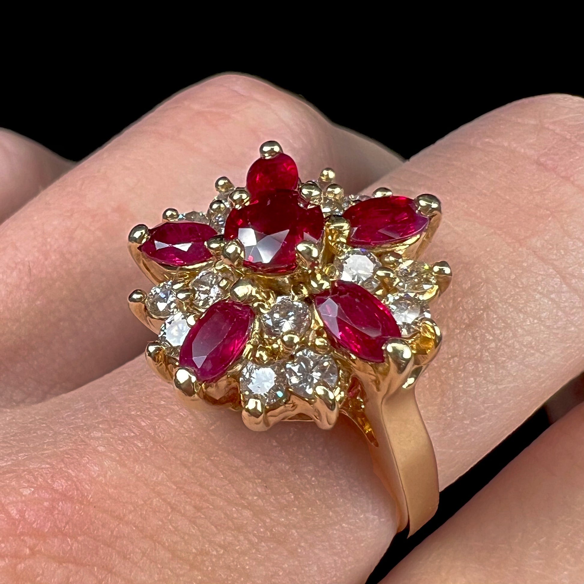 A ladies' vintage yellow gold cluster ring set with diamonds and pigeon blood red Burma rubies.
