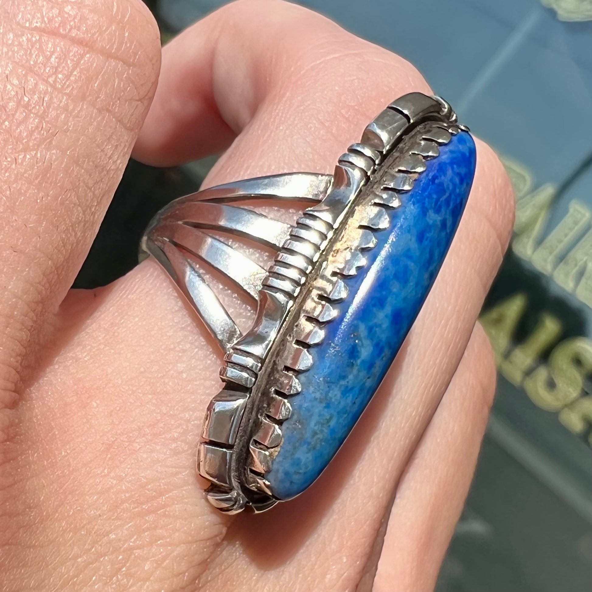A Navajo style sterling silver lapis lazuli ring engraved with the words "R. Bennett".