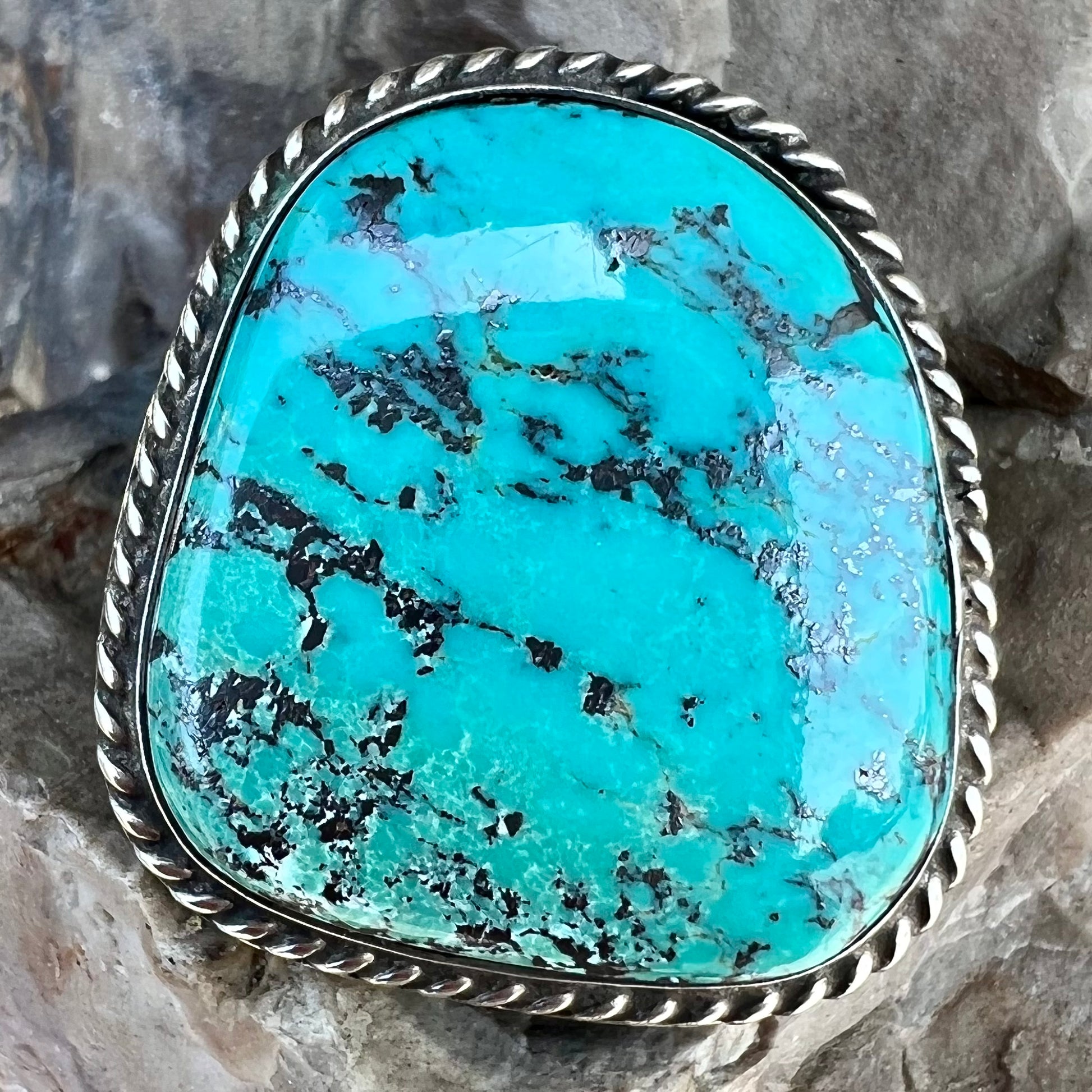 A men's sterling silver ring bezel set with a blue Morenci turquoise.  The ring is signed "SAM PIASO".