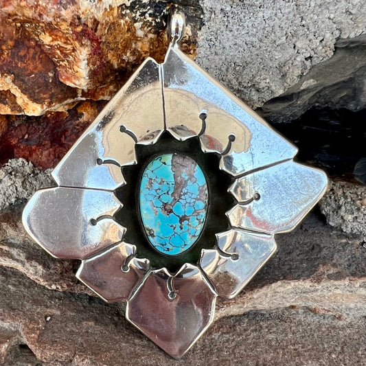 A handmade Mayan Indian pendant set with an oval cut turquoise stone from the Number 8 Mine.