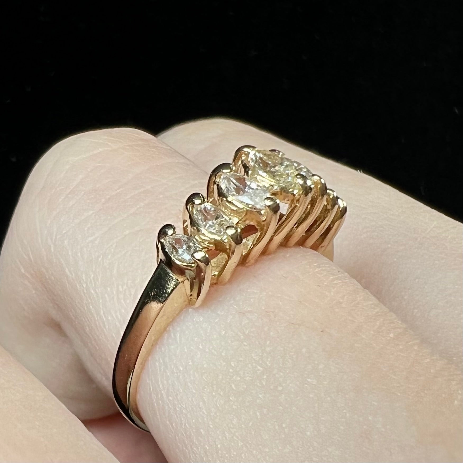An estate yellow gold ring prong set with seven marquise cut diamonds.