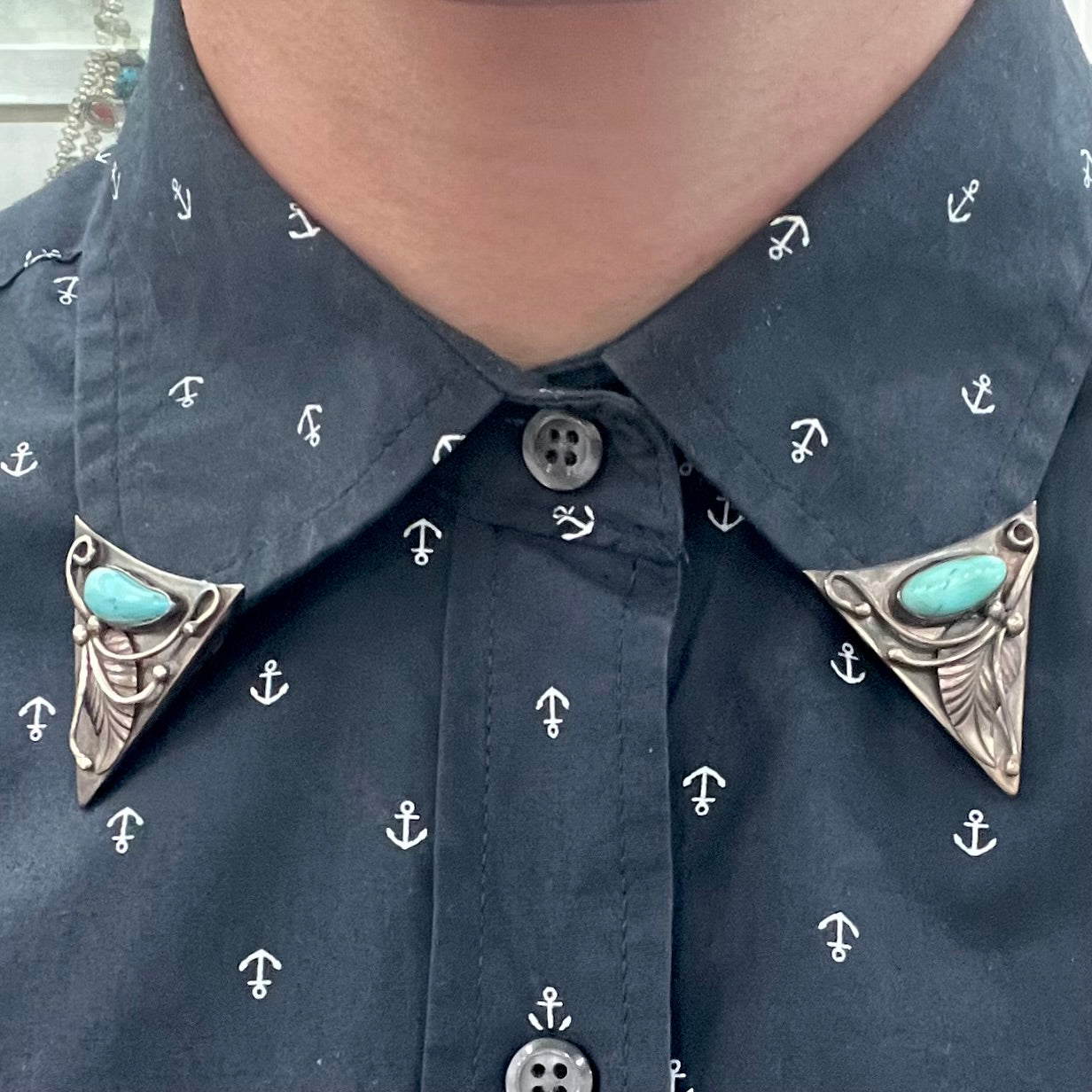 A pair of sterling silver and turquoise shirt collar tips handmade by Navajo artist, Phillip Guerro.