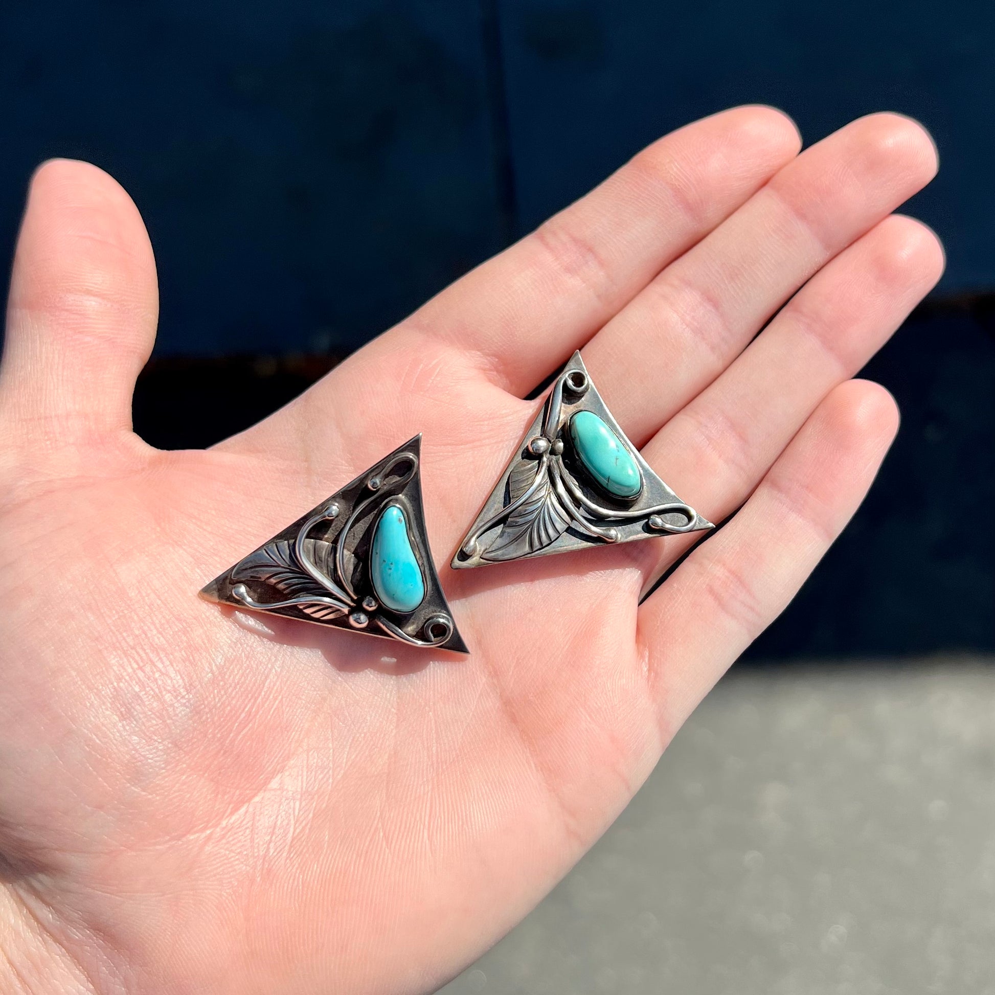 A pair of sterling silver and turquoise shirt collar tips handmade by Navajo artist, Phillip Guerro.