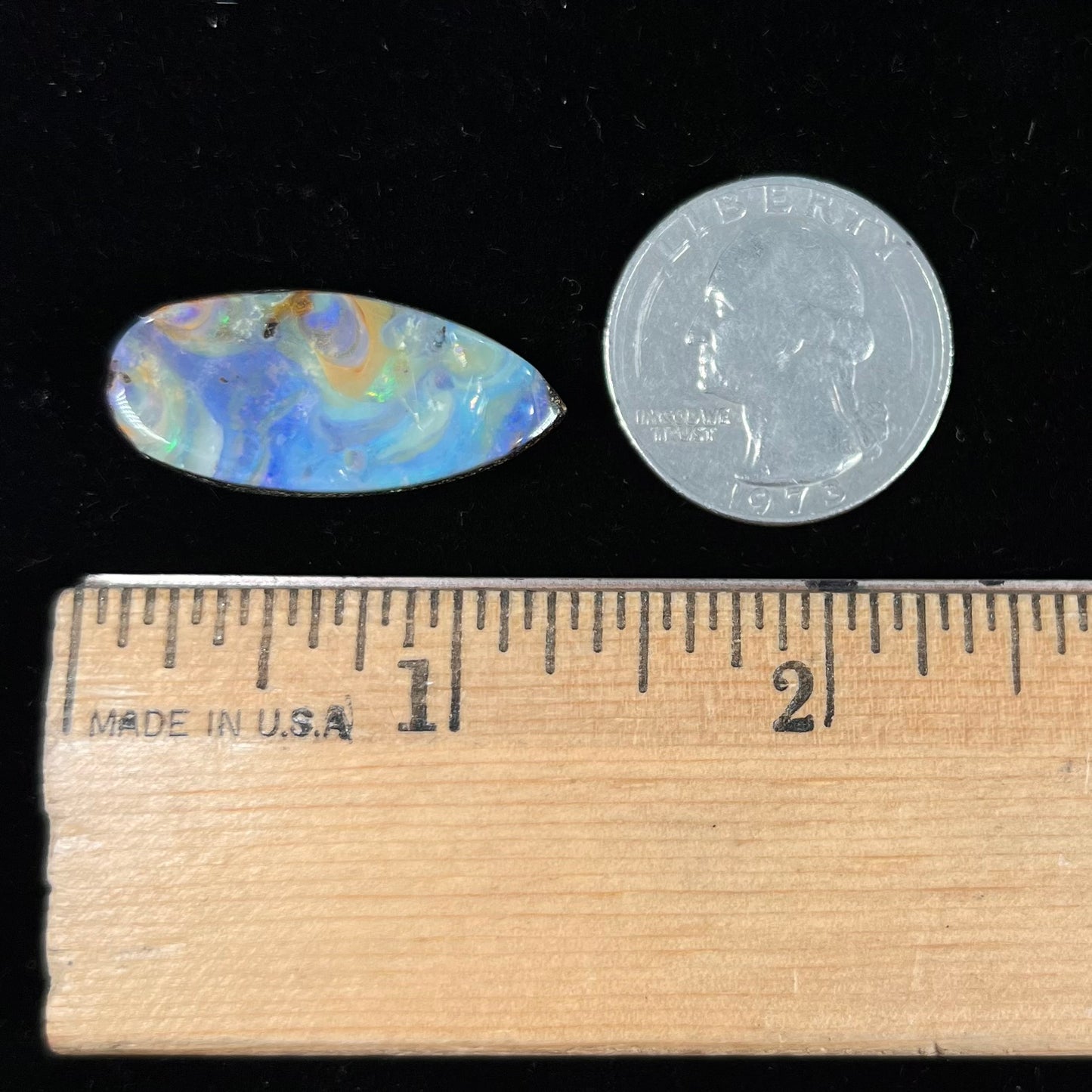 A loose, natural, pear shaped boulder opal stone from Quilpie, Australia.