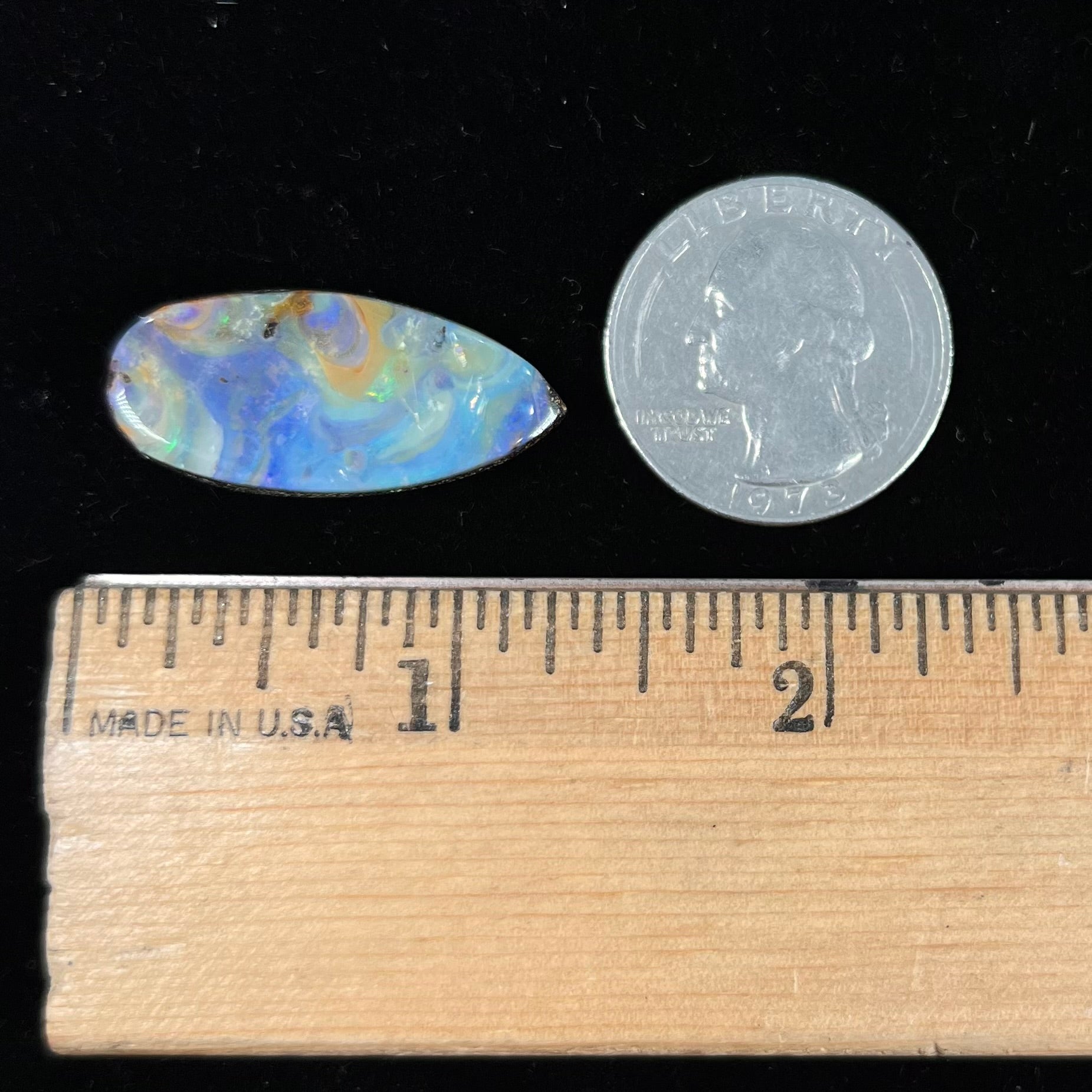 A loose, natural, pear shaped boulder opal stone from Quilpie, Australia.
