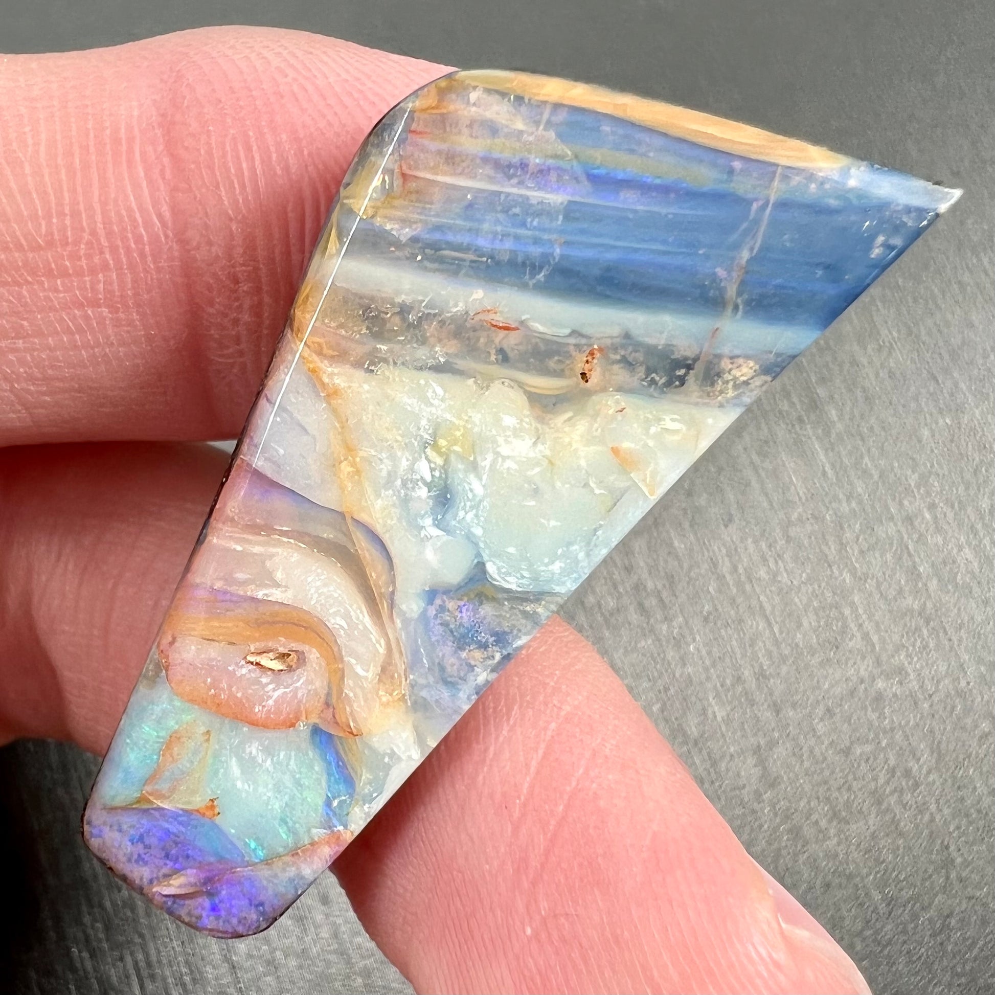 A loose, freeform cut, patterned Quilpie boulder opal stone from Queensland, Australia.