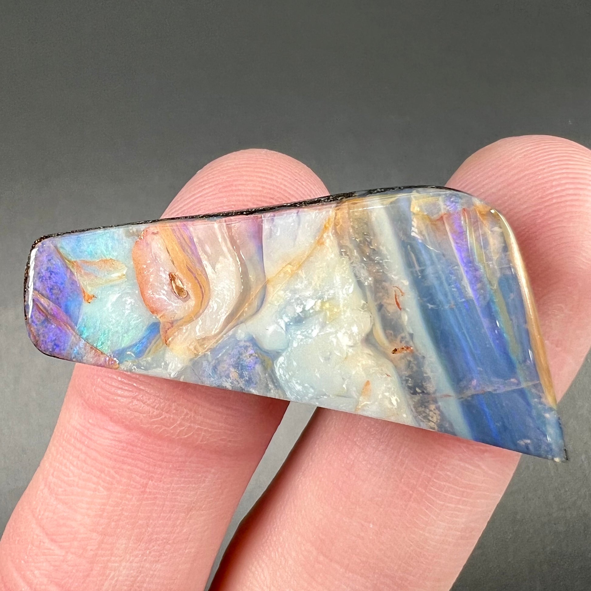 A loose, freeform cut, patterned Quilpie boulder opal stone from Queensland, Australia.