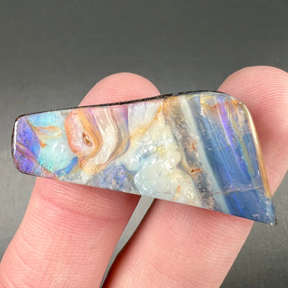 A loose, freeform cut, patterned Quilpie boulder opal stone from Queensland, Australia.