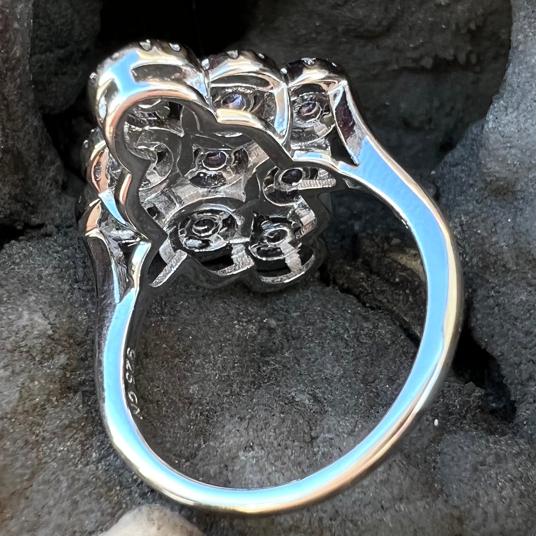 A silver ladies' ring set with 9 rose de France amethyst stones in white topaz halos.
