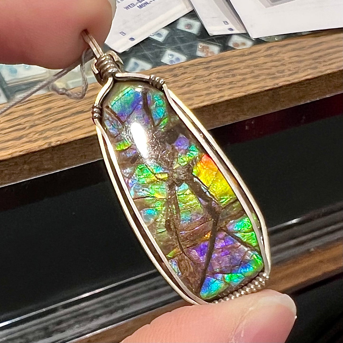 A sterling silver wire wrapped ammolite (gem quality rainbow ammonite) necklace.