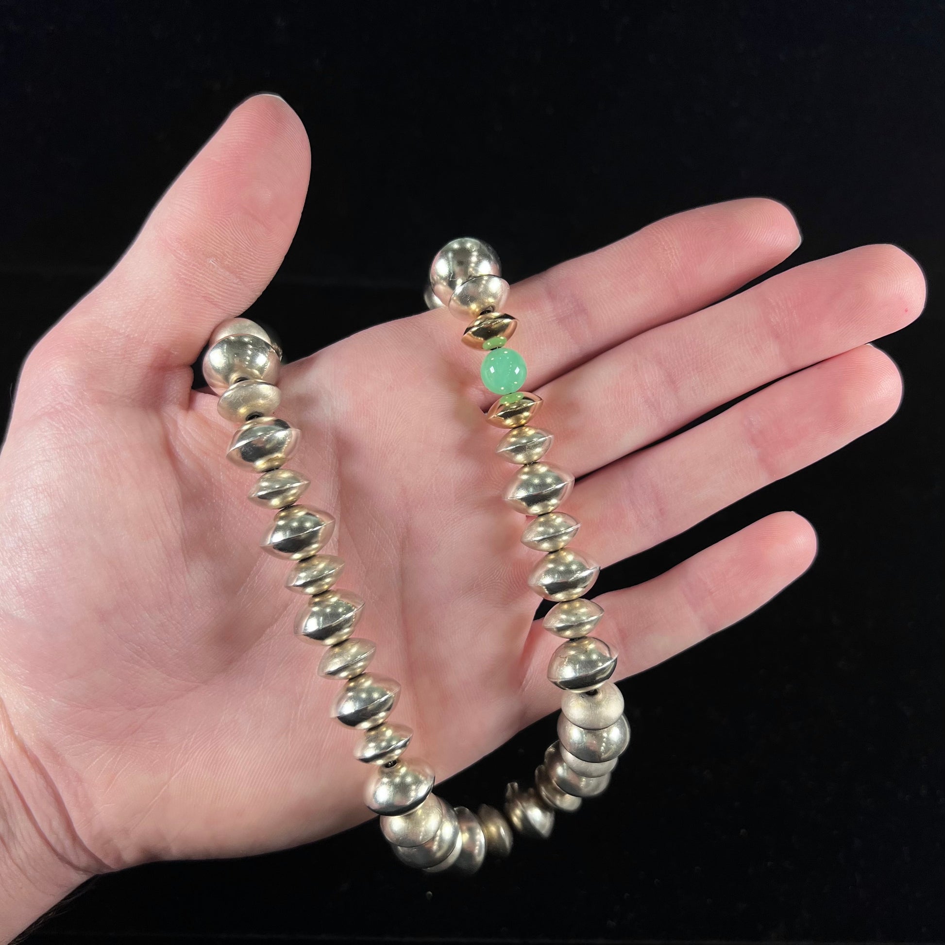 A silver, gold, and chrysoprase bead necklace handmade by Navajo artist, Alfred Joe.