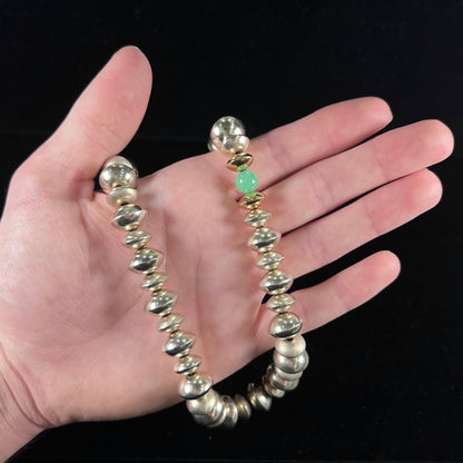 A silver, gold, and chrysoprase bead necklace handmade by Navajo artist, Alfred Joe.